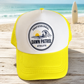 Professional Dawn Patrol Athlete yellow foam trucker hat on a beach

