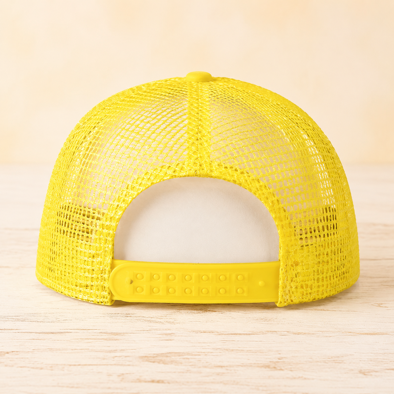 Back view of yellow mesh trucker hat with adjustable snapback