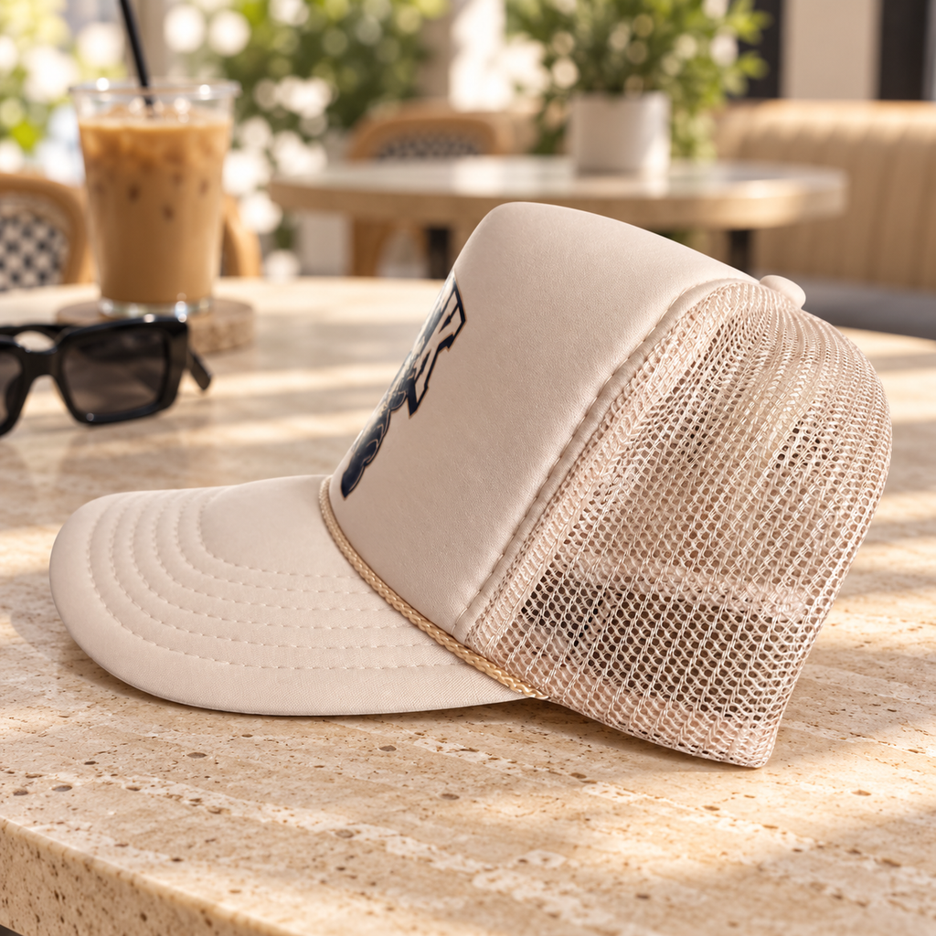 Side view of cream Clock It mesh-back trucker hat
